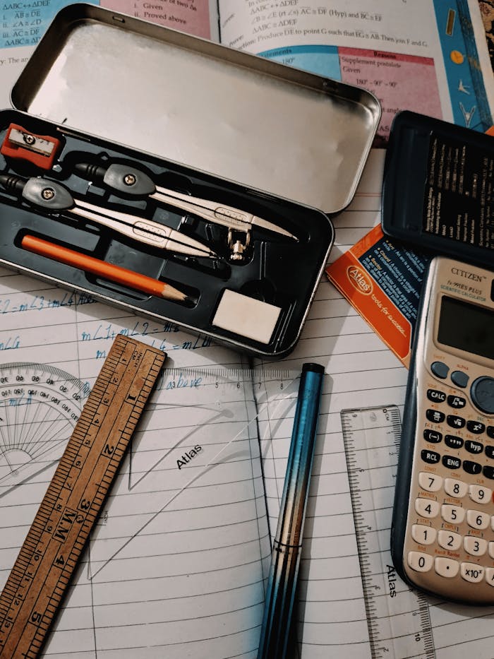 A collection of stationary tools for studying math, including a calculator, compass, and ruler.